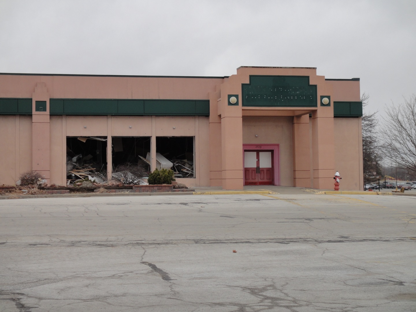 Exterior of Antioch Center and Chuck E. Cheese's during demolition.